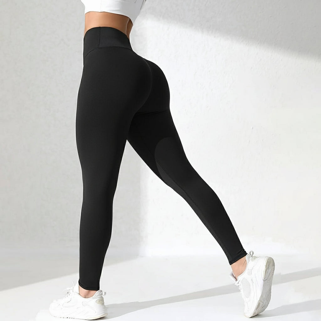 Person wearing black leggings with a flame graphic on a white background