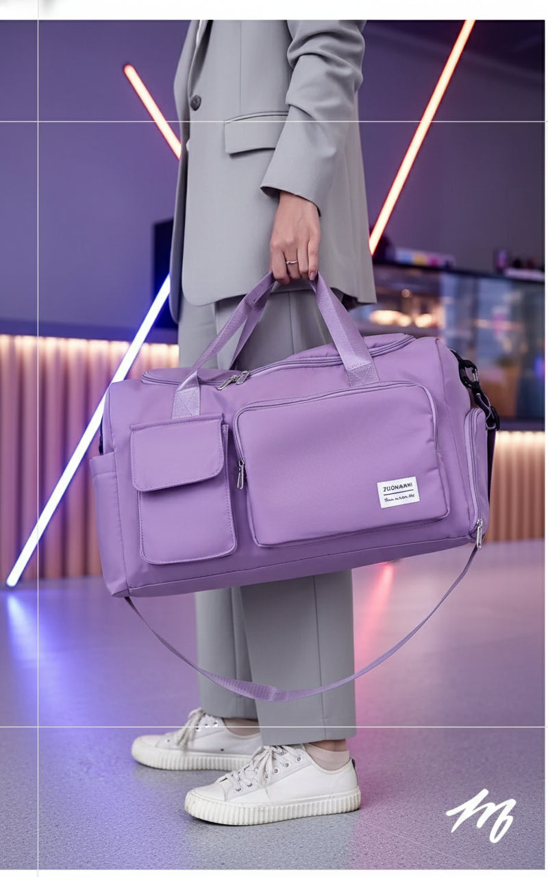 Purple travel duffel bag held by a person in an indoor setting
